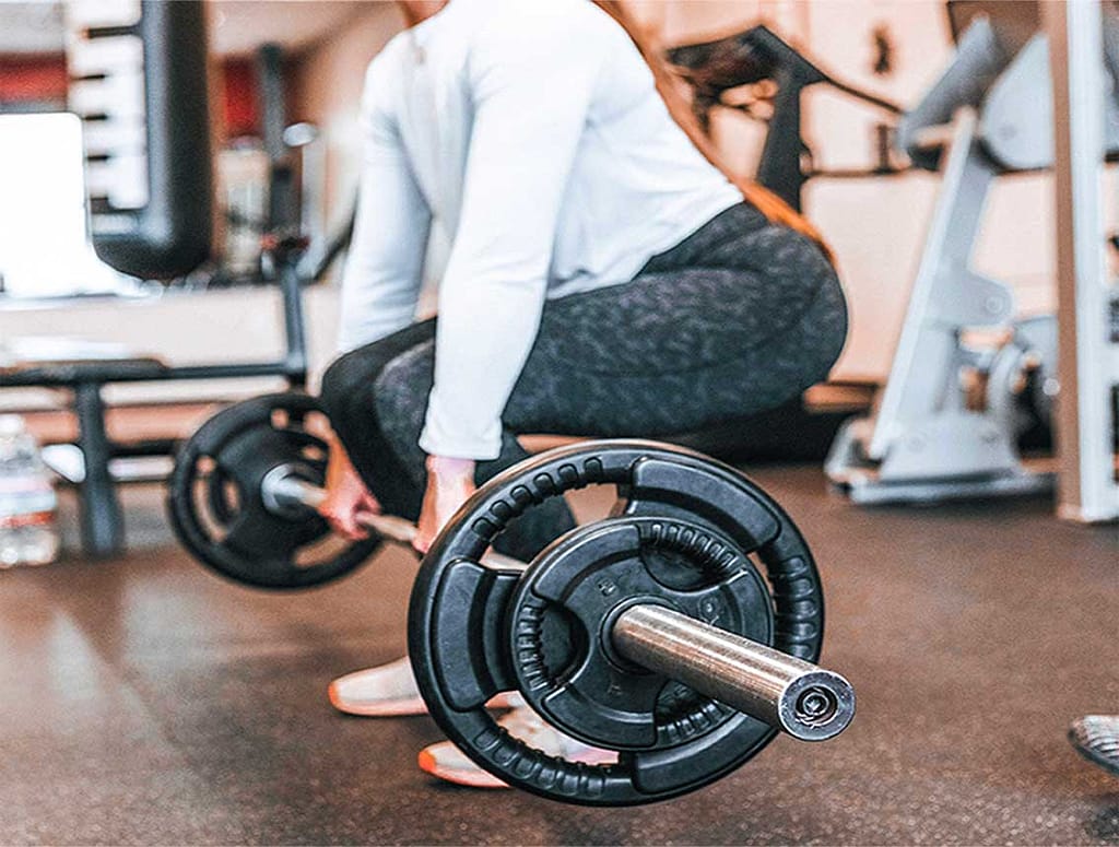 Image of a woman deadlifting weights